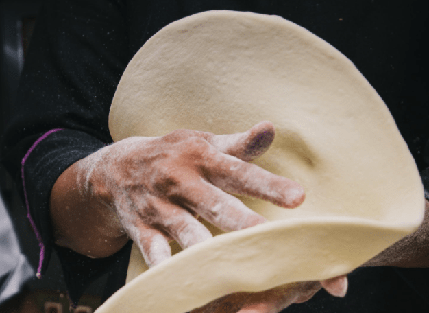 Spinning pizza dough